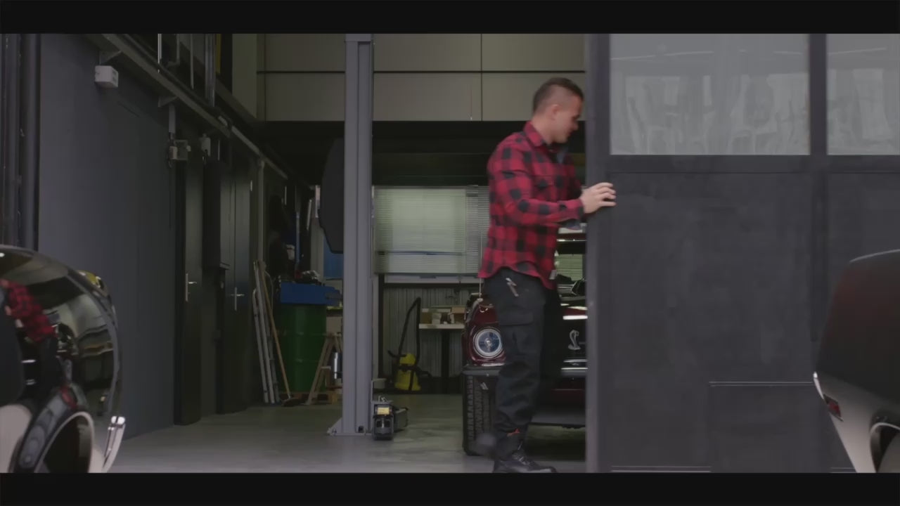 Load video: Mechanic prepares a vintage car in a garage, with interior driving shots and a classic vehicle in motion promoting Castrol GTX Classic oil.